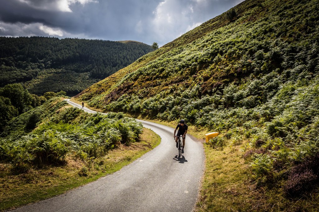 Cyclist riding uphill near Llangollen