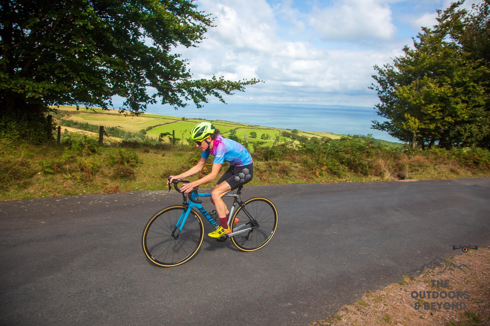 Female cyclist riding up hill.
